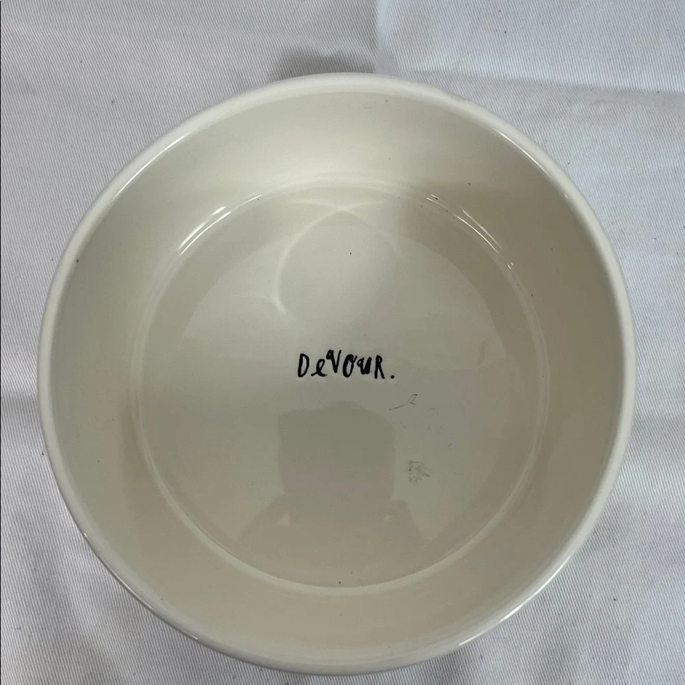 NWOT Rae Dunn white ceramic dog bowl 6” wide, 3” high. Paw print front, Devour